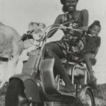 1949 lady and child on Lambretta scooter smiling