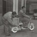 1950 man placing box on Lambretta scooter with another man on it