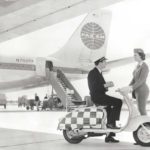 1960 man and lady with Lambretta scooter in front of Pan Am airplane