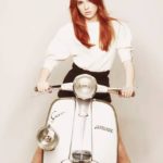 Karen Gillan on white Lambretta scooter