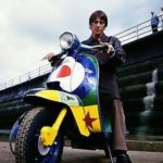 Paul Weller on colored Lambretta scooter
