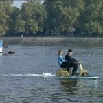 Two persons on Lambretta on water